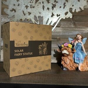 Solar Angel Garden Statue - Garden Fairy Sitting on a Highland Cow